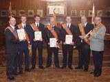 City Grand Master Wor Bro Victor Wray and Worshipful Master Bro Kenneth Kincaid presenting new members with their initiation certificates
